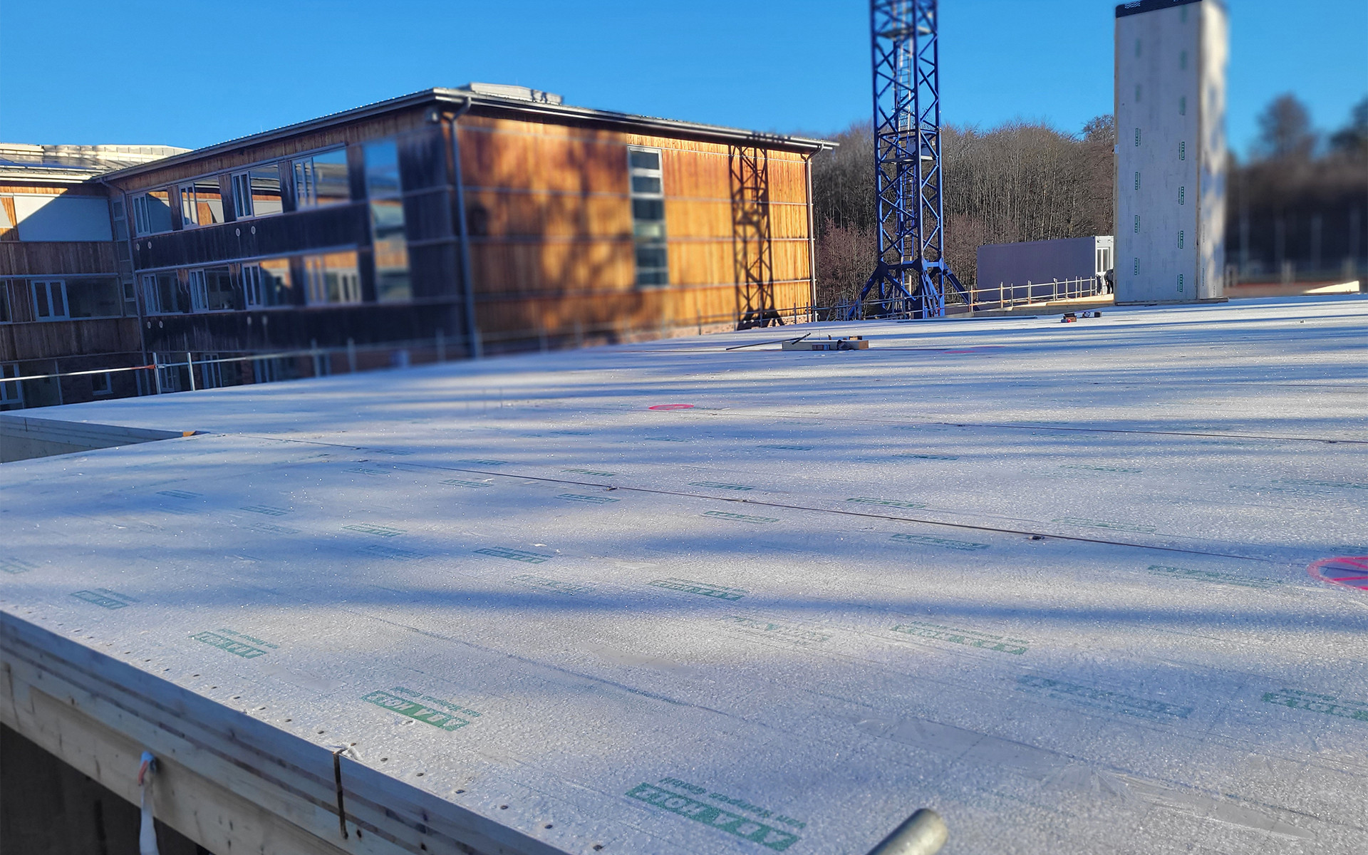 Public school building in CLT under construction in Germany, prefabricated panels ready for assembly