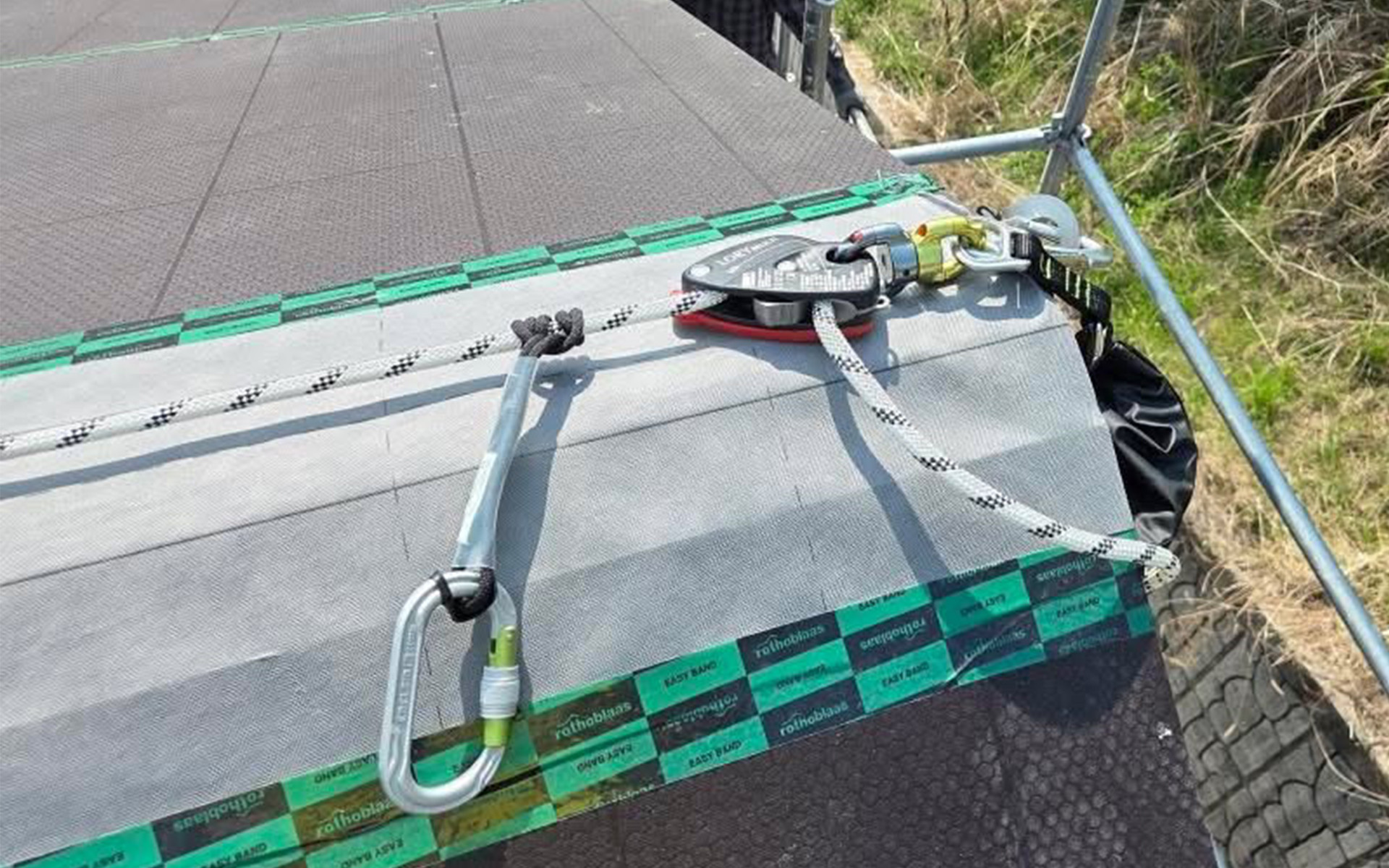 Workers installing HOLD-SYSTEM® on a sloped roof in South Korea